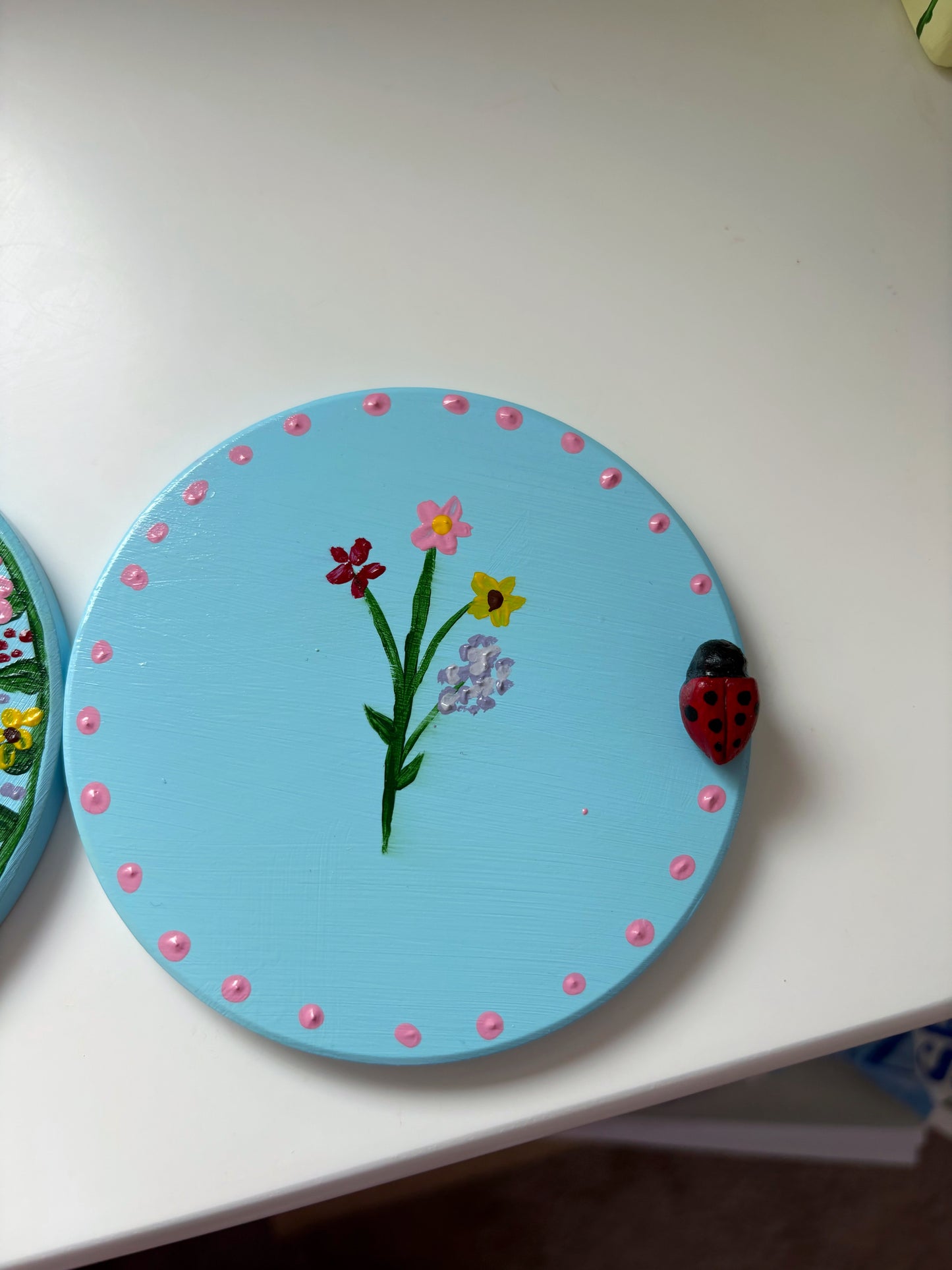 Pastel wildlife coasters, with hand painted wild flowers and a clay ladybug.