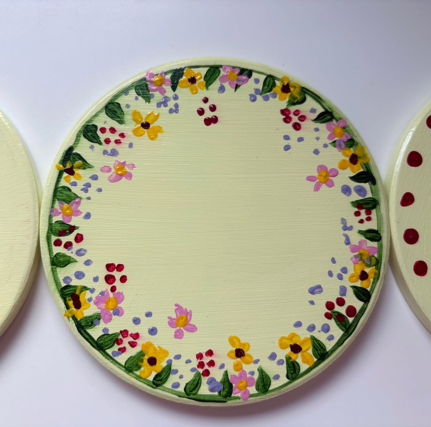 Pastel wildlife coasters, with hand painted wild flowers and a clay ladybug.