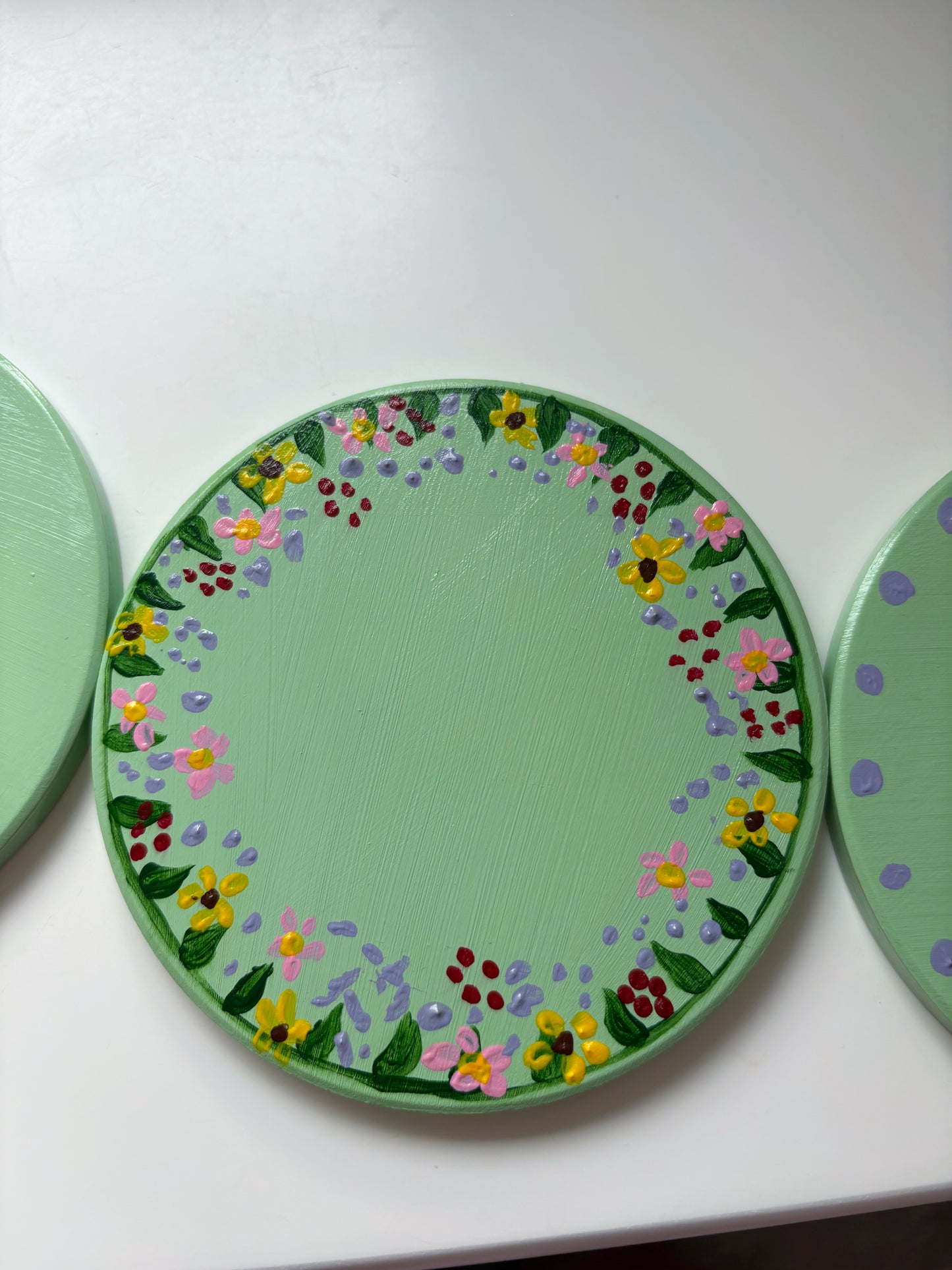 Pastel wildlife coasters, with hand painted wild flowers and a clay ladybug.