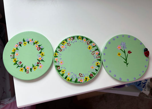 Pastel wildlife coasters, with hand painted wild flowers and a clay ladybug.