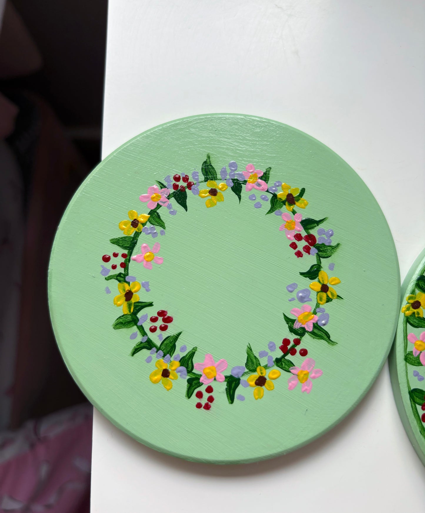 Pastel wildlife coasters, with hand painted wild flowers and a clay ladybug.