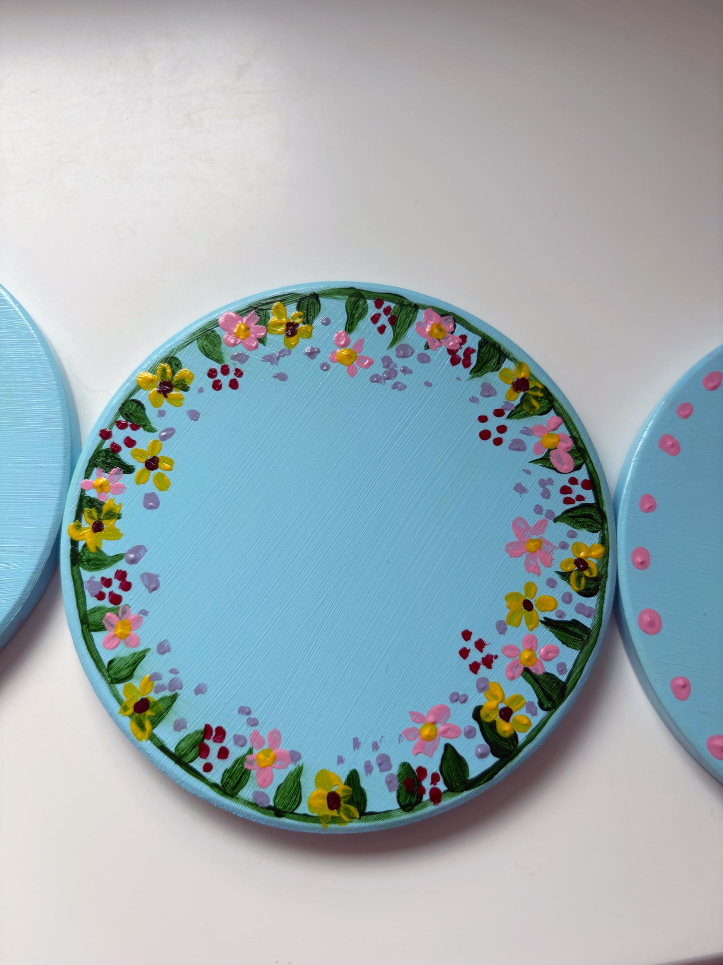 Pastel wildlife coasters, with hand painted wild flowers and a clay ladybug.