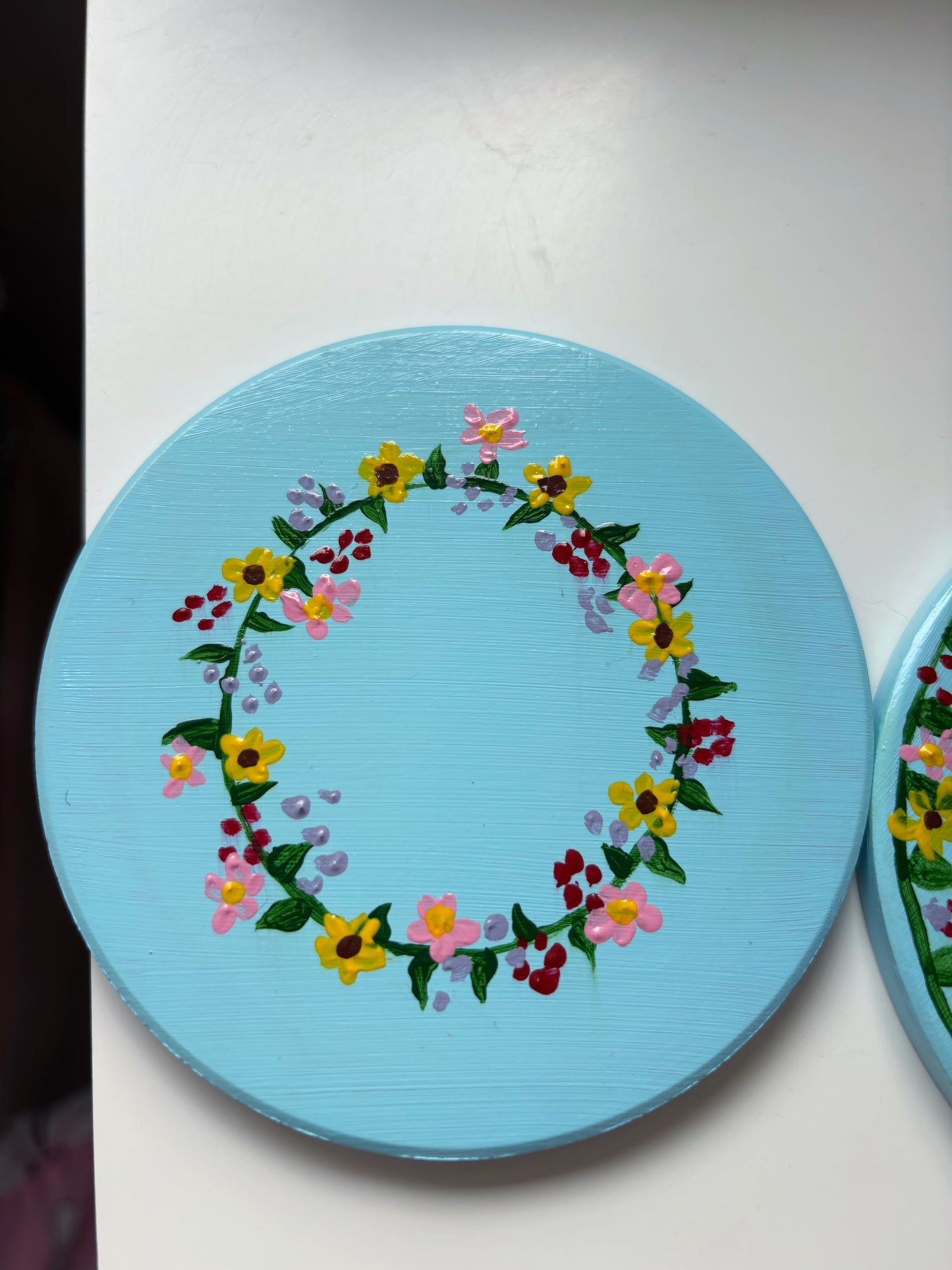 Pastel wildlife coasters, with hand painted wild flowers and a clay ladybug.