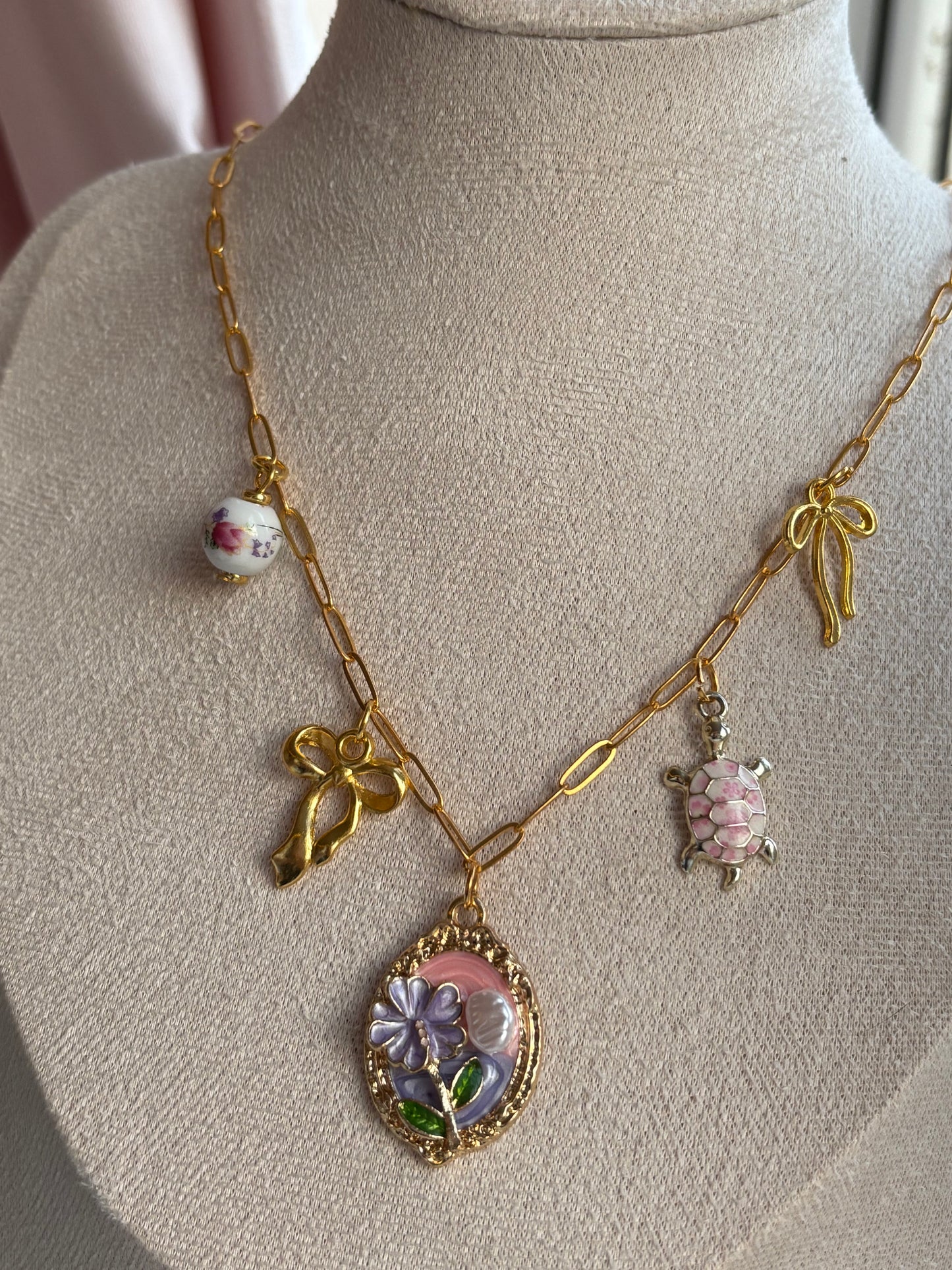 Pink and gold charm necklace
