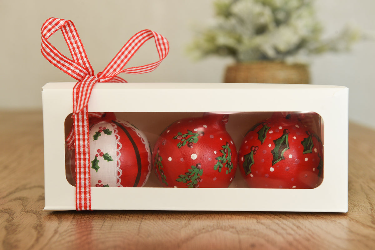 Set of three hand painted christmas baubles in pink, blue and red