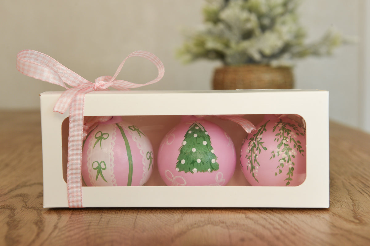 Set of three hand painted christmas baubles in pink, blue and red