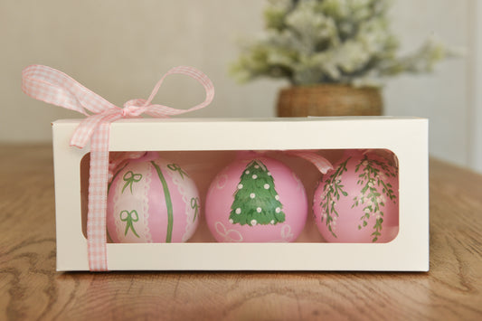 Set of three hand painted christmas baubles in pink, blue and red